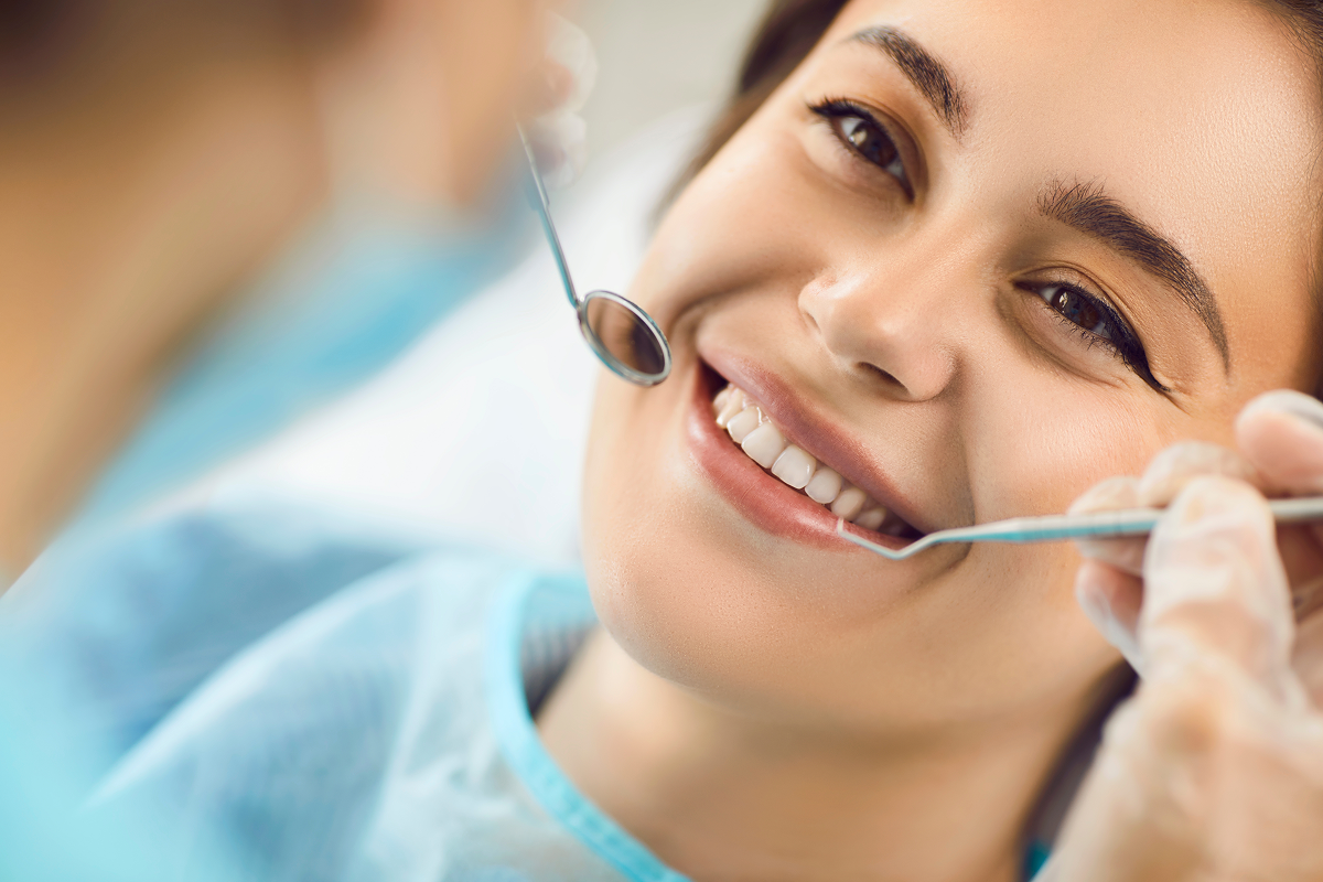Dentist examining a patient’s teeth after a dental filling